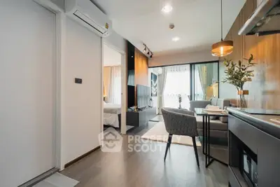 Modern open-plan living room with dining area and stylish decor in a contemporary apartment.
