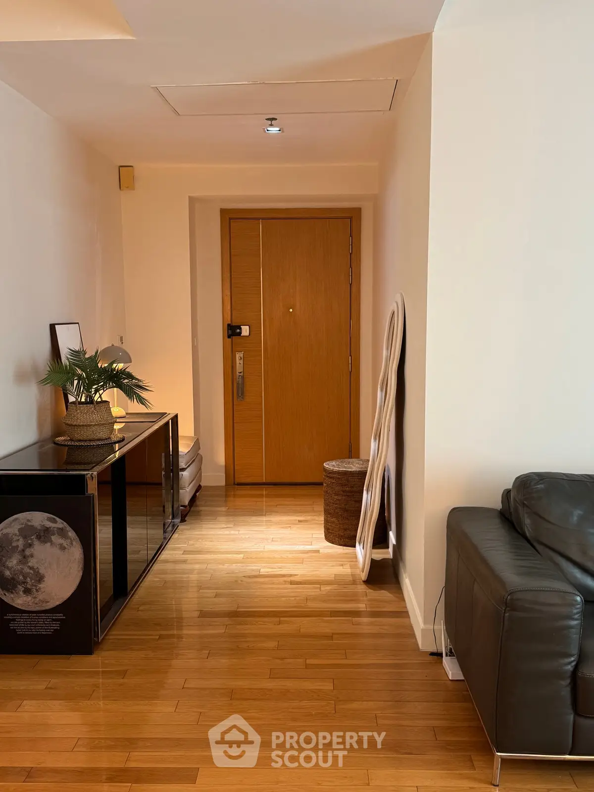 Stylish apartment entrance with wooden flooring and modern decor