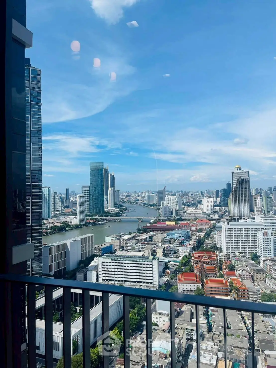 Stunning cityscape view from high-rise balcony with clear blue sky