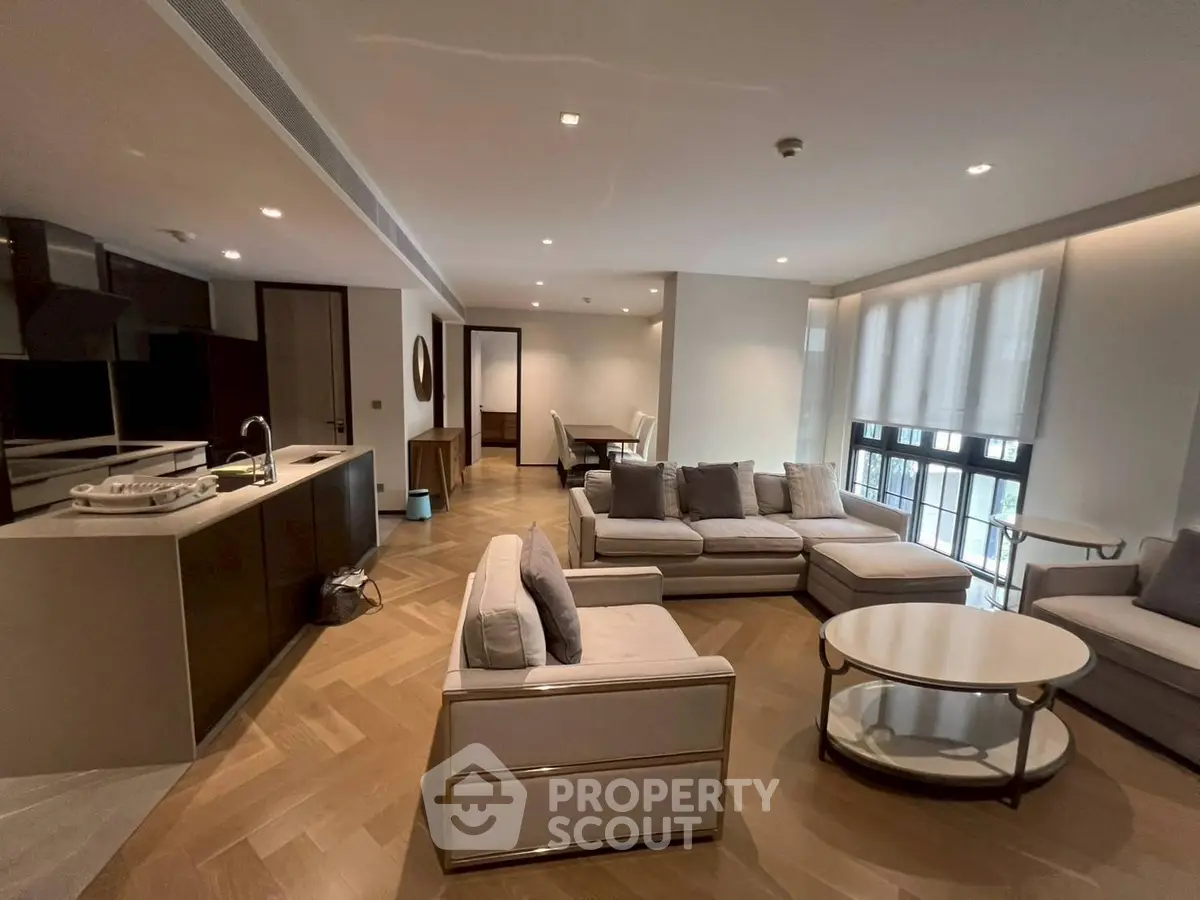 Spacious modern living room with open kitchen and elegant furnishings