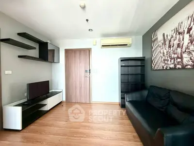 Modern living room with sleek furniture and wall art in a stylish apartment.