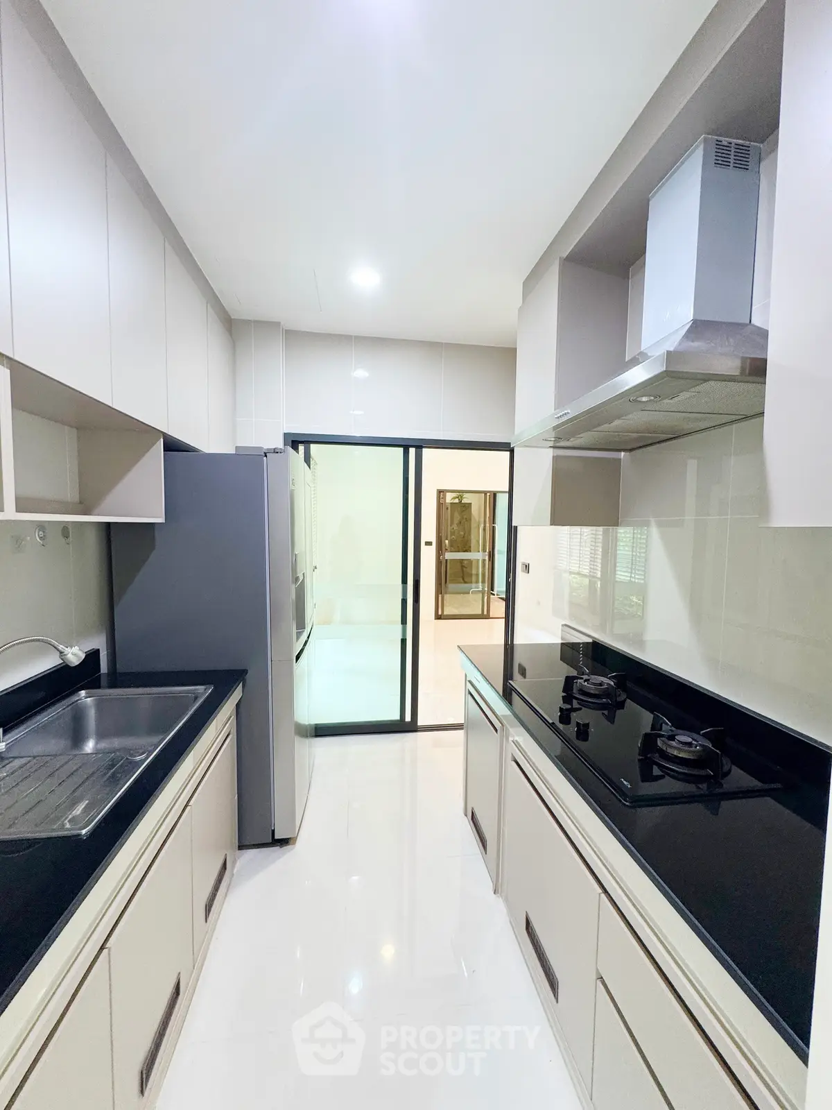 Modern kitchen with sleek cabinetry and gas stove in a contemporary home.