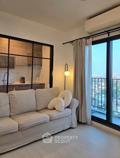 Modern living room with cozy sofa and city view balcony in stylish apartment