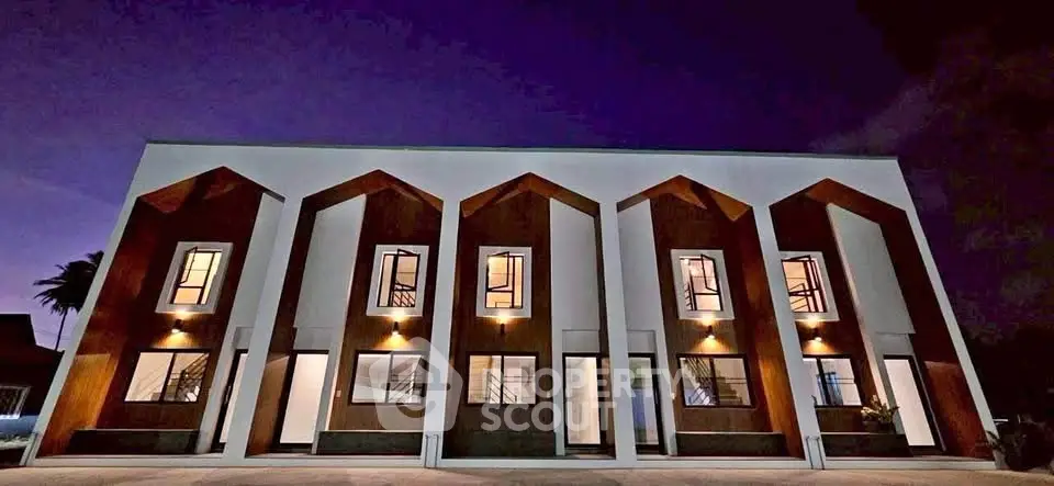 Stunning modern building exterior with unique architectural design and ambient lighting at dusk.
