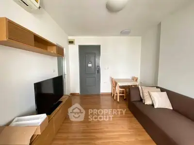 Modern living room with wooden flooring, sleek furniture, and a cozy atmosphere.
