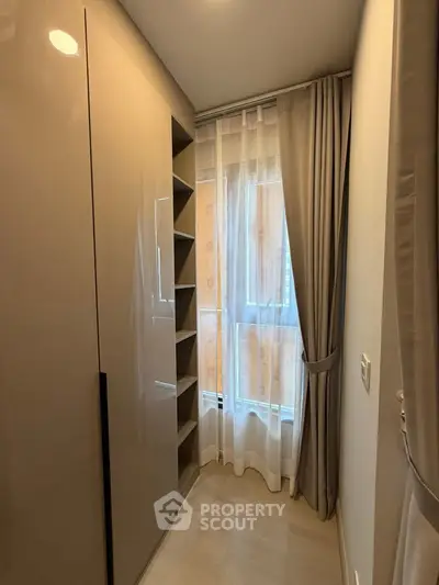 Stylish walk-in closet with modern shelving and natural light