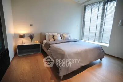 Modern bedroom with elegant decor and large window for natural light