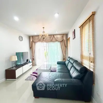 Spacious living room with elegant decor and large windows for natural light.