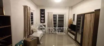 Spacious living room with modern decor and large windows for natural light.