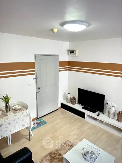 Cozy living room with modern decor and TV setup, perfect for relaxation and entertainment.