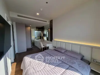 Modern bedroom with stylish decor and ample natural light, featuring a cozy bed and sleek furniture.