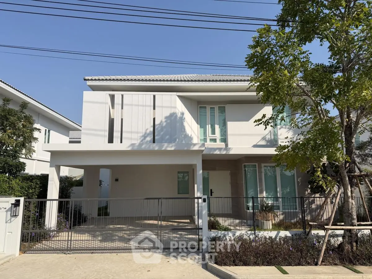 Modern two-story house with sleek design and spacious driveway in a serene neighborhood.
