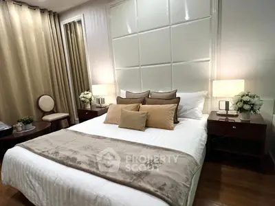 Luxurious bedroom with elegant decor and plush bedding in modern apartment.