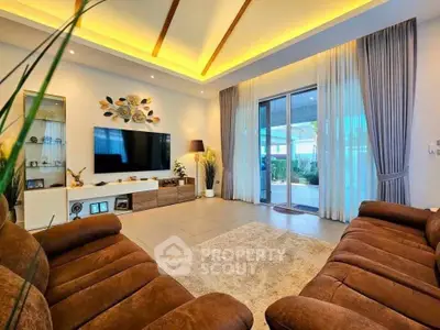 Luxurious living room with modern decor, plush sofas, and ambient lighting, perfect for relaxation and entertainment.