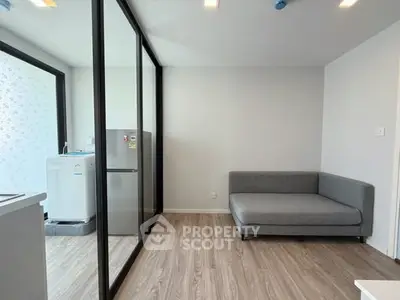 Modern living room with glass partition and washing machine