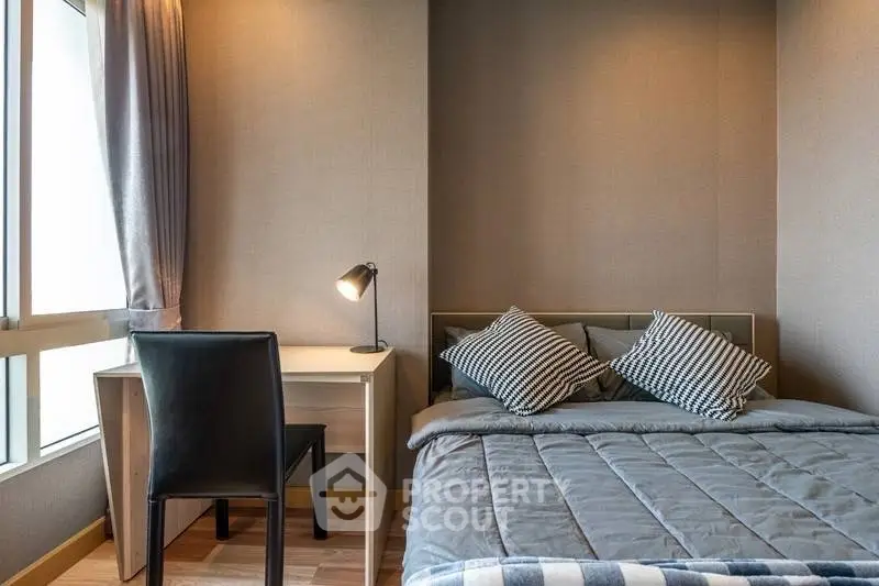 Cozy bedroom with modern decor, featuring a comfortable bed and a study desk by the window.