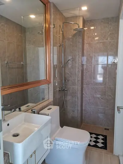 Modern bathroom with sleek shower and elegant fixtures in a stylish real estate property.
