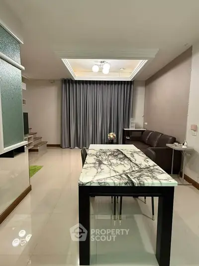 Modern living room with marble dining table and elegant lighting