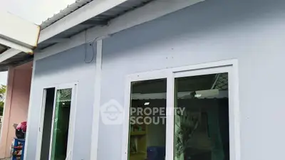 Charming single-story home exterior with sliding glass doors and modern design.