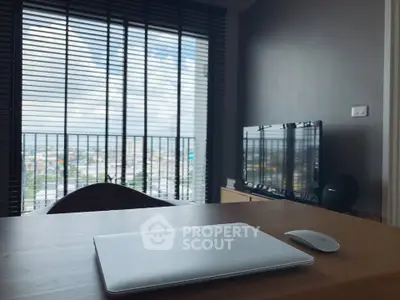 Modern apartment with city view, featuring sleek furniture and large windows for natural light.