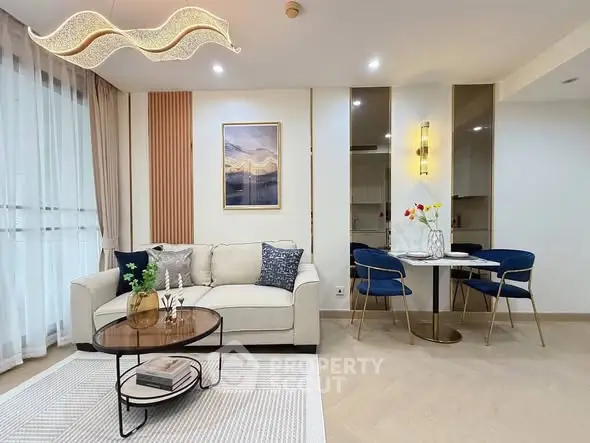 Modern living room with elegant decor and dining area, featuring stylish furniture and ambient lighting.