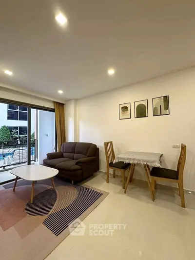Modern living room with cozy sofa, stylish decor, and balcony view