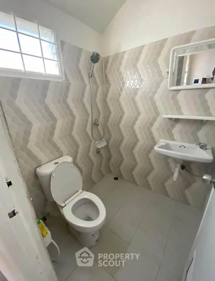 Modern bathroom with stylish tile design and compact fixtures