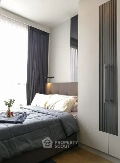 Modern bedroom with stylish decor and ample natural light