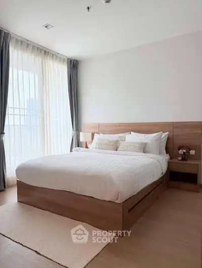 Spacious modern bedroom with large windows and elegant decor