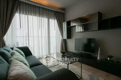 Modern living room with sleek furniture and large window for natural light.