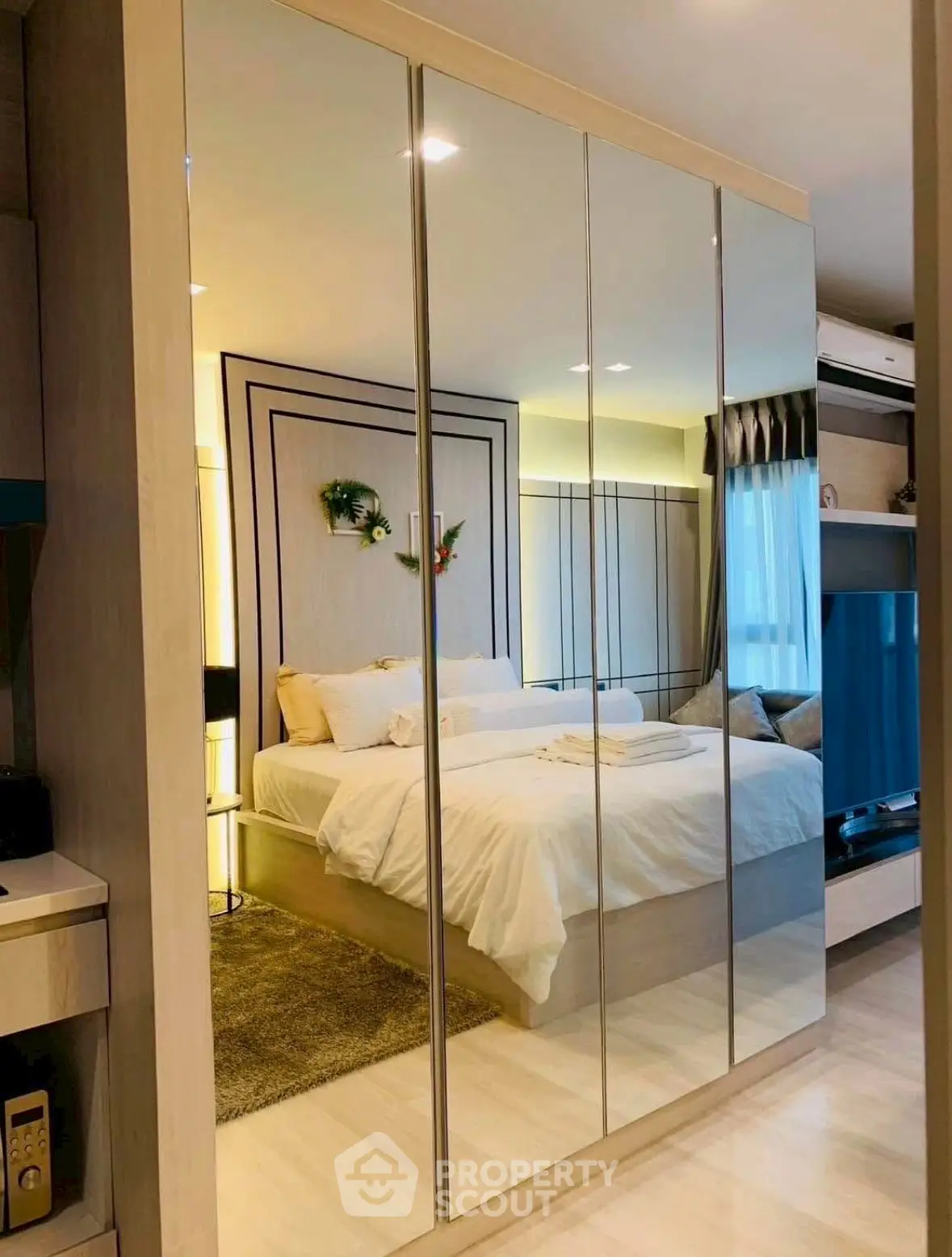 Luxurious bedroom with mirrored wardrobe and elegant decor