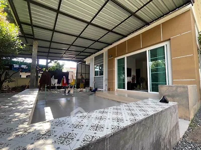 Modern covered patio with tiled flooring and sliding glass doors