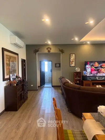 Spacious living room with modern decor and comfortable seating, perfect for relaxation and entertainment.
