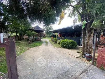 Charming rural property with spacious outdoor area and lush greenery, perfect for serene living.