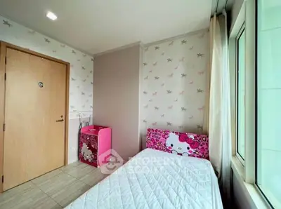 Charming bedroom with playful wallpaper and cozy bed, perfect for a child's room.