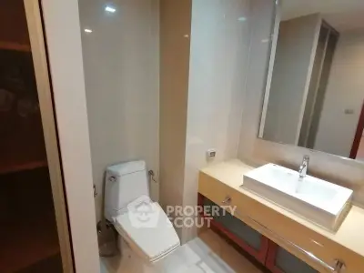 Modern bathroom with sleek fixtures and elegant design, featuring a stylish sink and toilet.