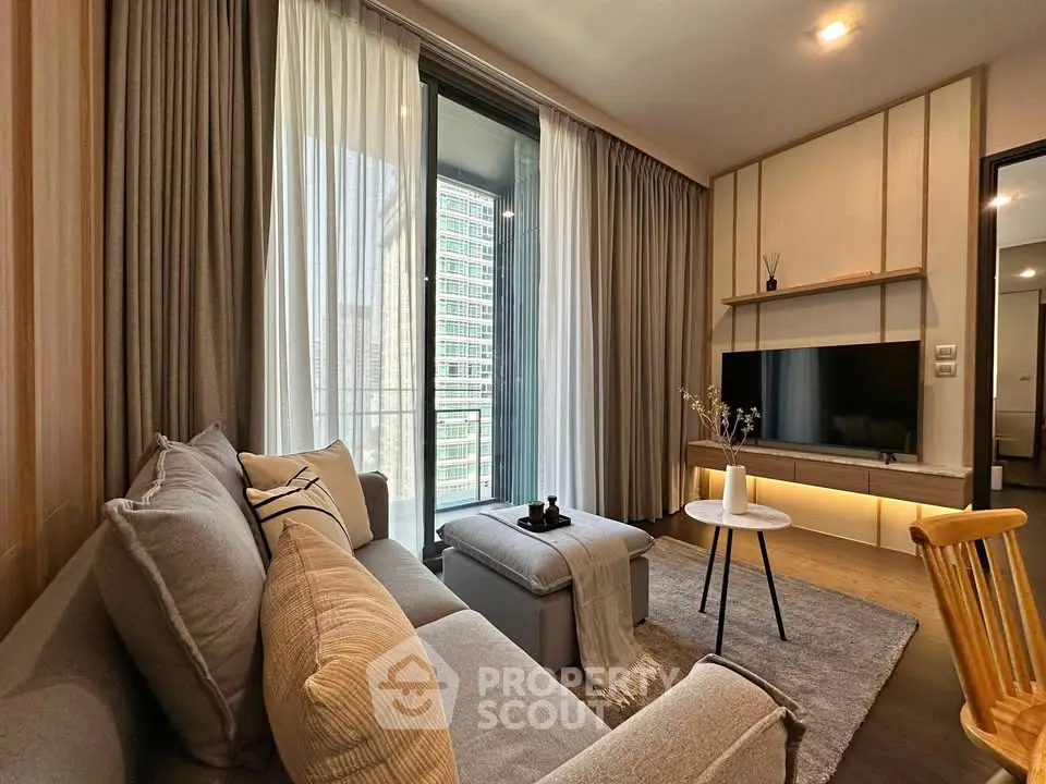 Modern living room with cozy sofa, stylish decor, and large window offering city view.