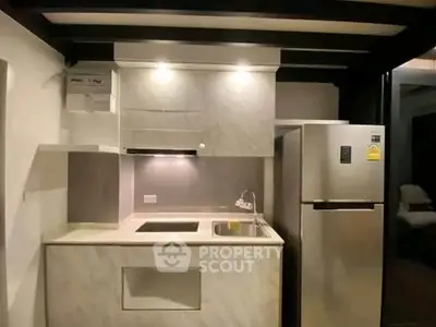 Modern compact kitchen with sleek appliances and stylish cabinetry