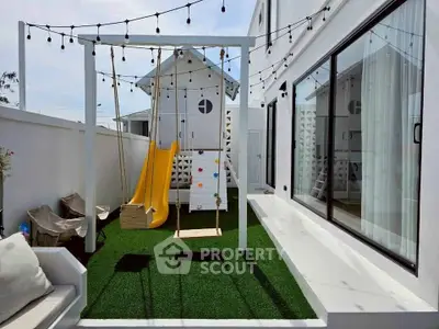 Charming backyard with swing set and cozy seating area, perfect for family relaxation.