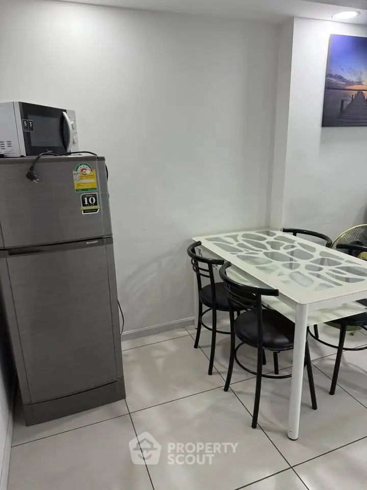 Modern kitchen with sleek fridge and stylish dining table set