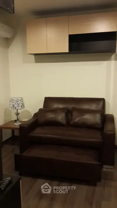 Cozy living room with brown leather sofa and modern decor
