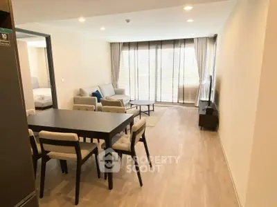 Spacious modern living room with elegant dining area and large windows