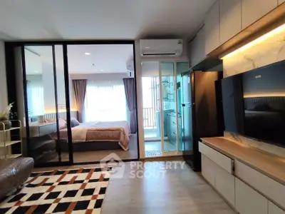 Modern apartment interior with spacious living room and bedroom, featuring stylish decor and ample natural light.