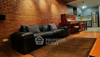 Charming living room with exposed brick wall and cozy leather sofa