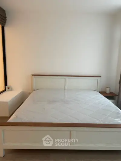 Spacious bedroom with large windows allowing ample natural light, featuring a king-sized bed frame ready for a luxurious mattress, ideal for a restful retreat in a modern home.