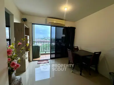 Cozy living room with balcony and city view, featuring modern furniture and air conditioning.