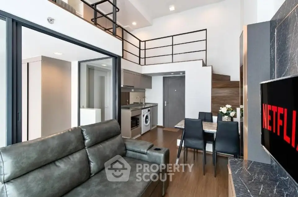 Modern loft apartment with open living area, sleek kitchen, and stylish mezzanine.