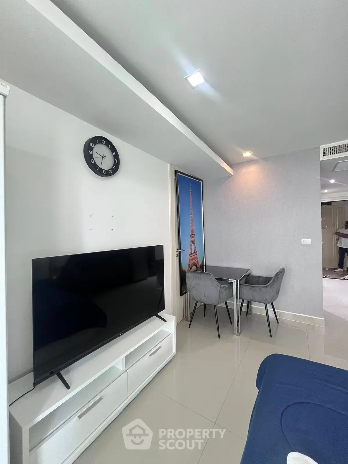 Modern living room with sleek TV unit and cozy dining area