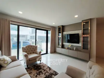 Spacious modern living room with elegant furniture and large windows for natural light.