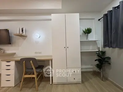 Modern study room with sleek desk, chair, and storage cabinet, featuring minimalist decor and neutral tones.